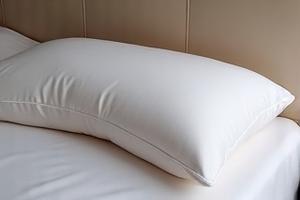 Sleep & Glow Omnia Pillow on a bed.